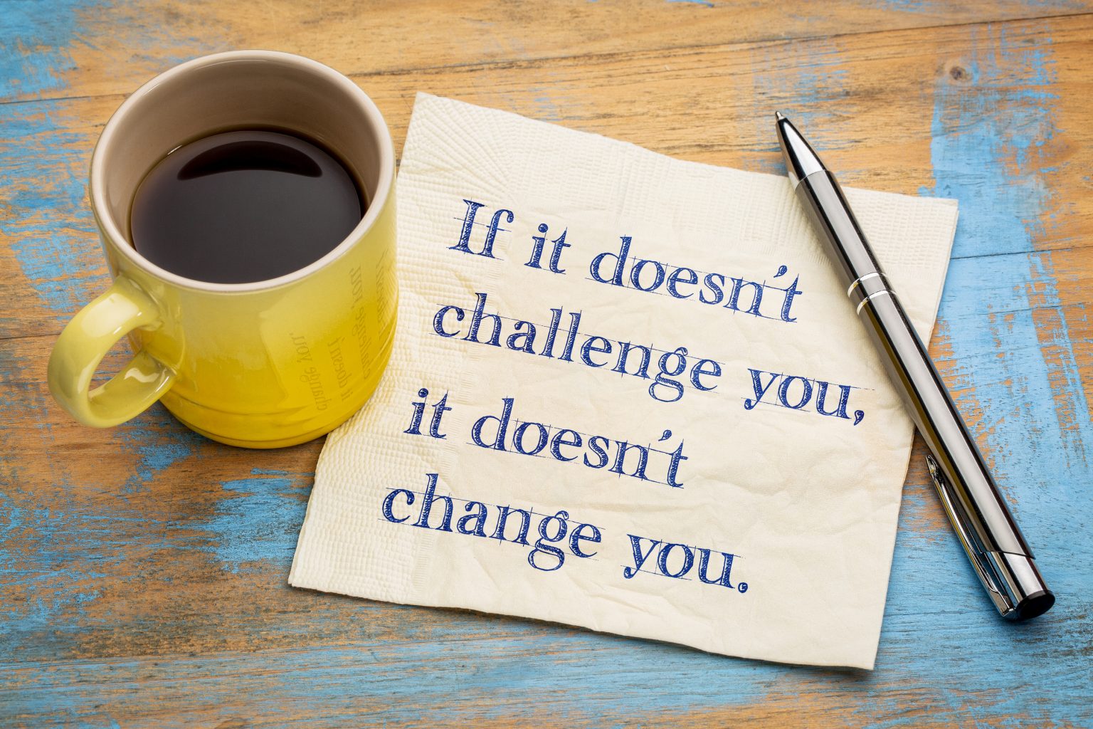 If it doesn't challenge you, it doesn't change you. Photo of coffee cup and memo